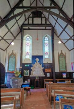 A view of the west end and window and patteson memorial in Alfington church