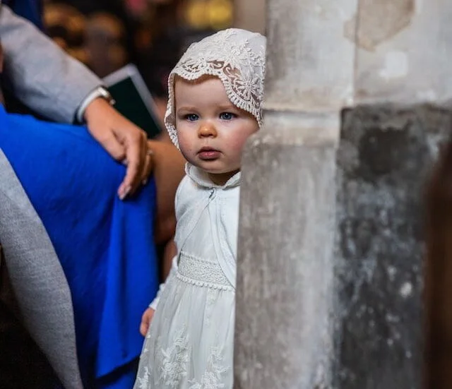 A child in baptism gown during a baptism service