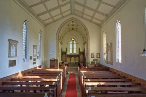 A view inside Escot church looking east down the nave to the altar