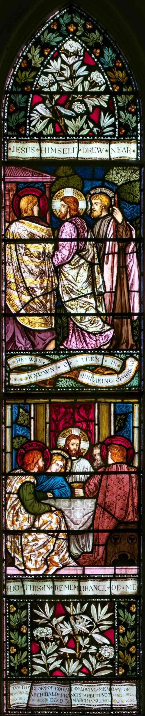 A stained glass window in Escot church depicting the road to Emmaus