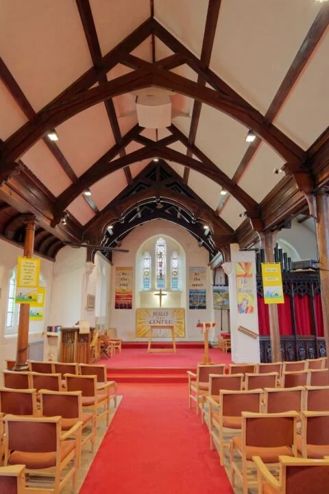 A view looking east in Newton Poppleford church down the nave to the altar and east window