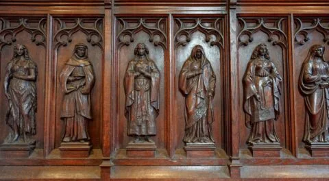 A view of the left side of the screen in Newton Poppleford church showing carved ladies from the Bible