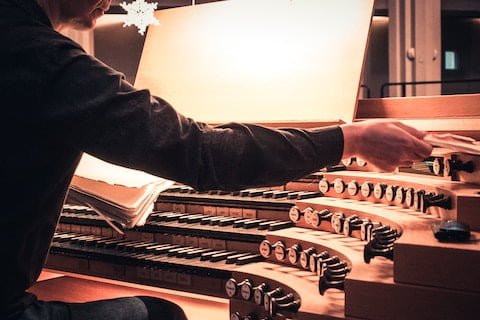 An organist playing an organ in church