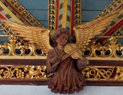 A view of one of the carved angels playing a violin at Payhembury church