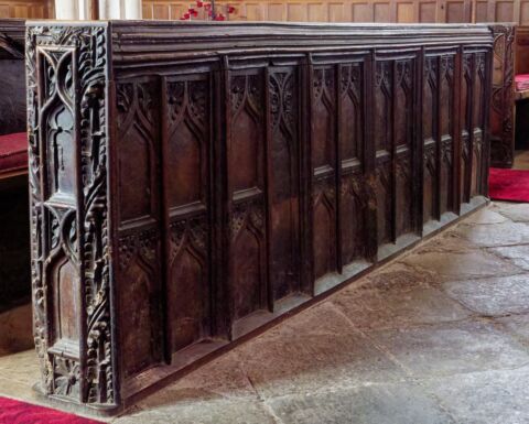 A view of an ornate carved pew frontal