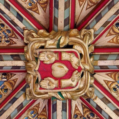 A view of one of the ceiling bosses in Payhembury church depicting the piercings of Christ