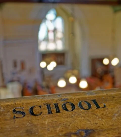 A view of the gallery rail at Tipton St John church with School engraved into it