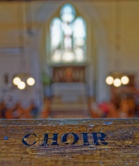 A view of the gallery rail at Tipton St John church with Choir engraved into it