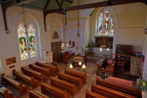 A view inside Tipton St John church from the raised gallery at the nave and altar