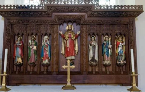 A view of the ornate carved and painted reredos in Tipton St John church