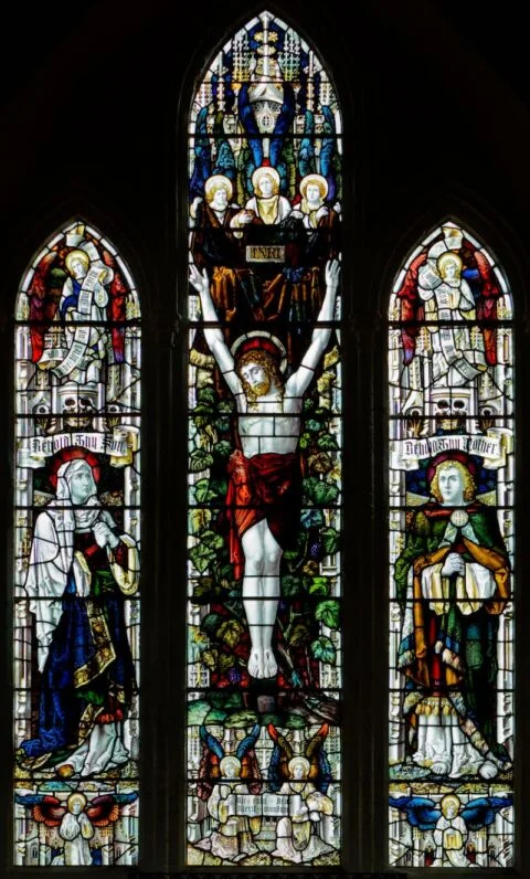 A view of the east window in Tipton St John church depicting the crucifixion