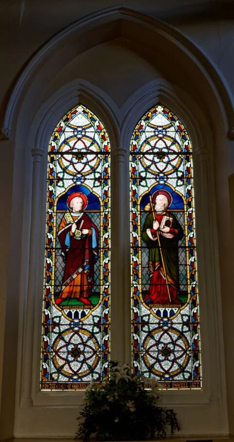 A window in Tipton St John church depicting St Peter and St James the Great