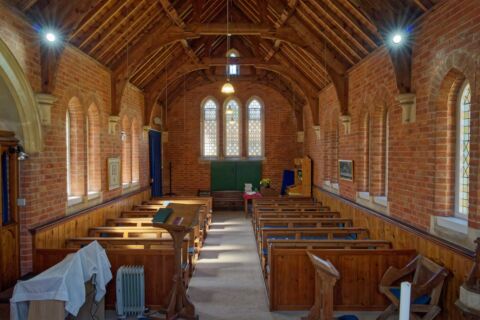 Inside Wiggaton church looking west down the nave