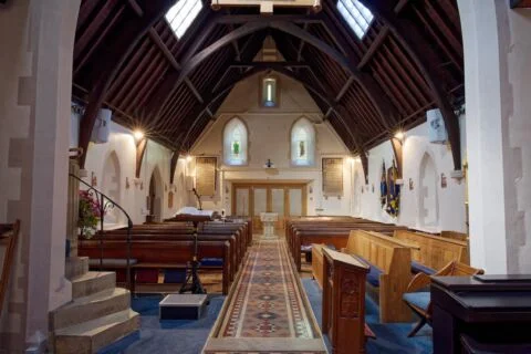 A full width view inside West Hill church from the altar looking west