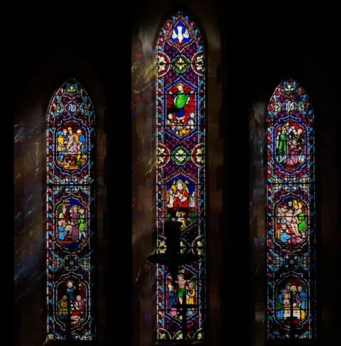 A view of the three panel east window in West Hill church depicting the crucifixion and resurrection